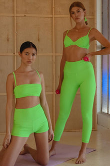 Lime green micro rib wide band legging on model, high-waisted cropped length.