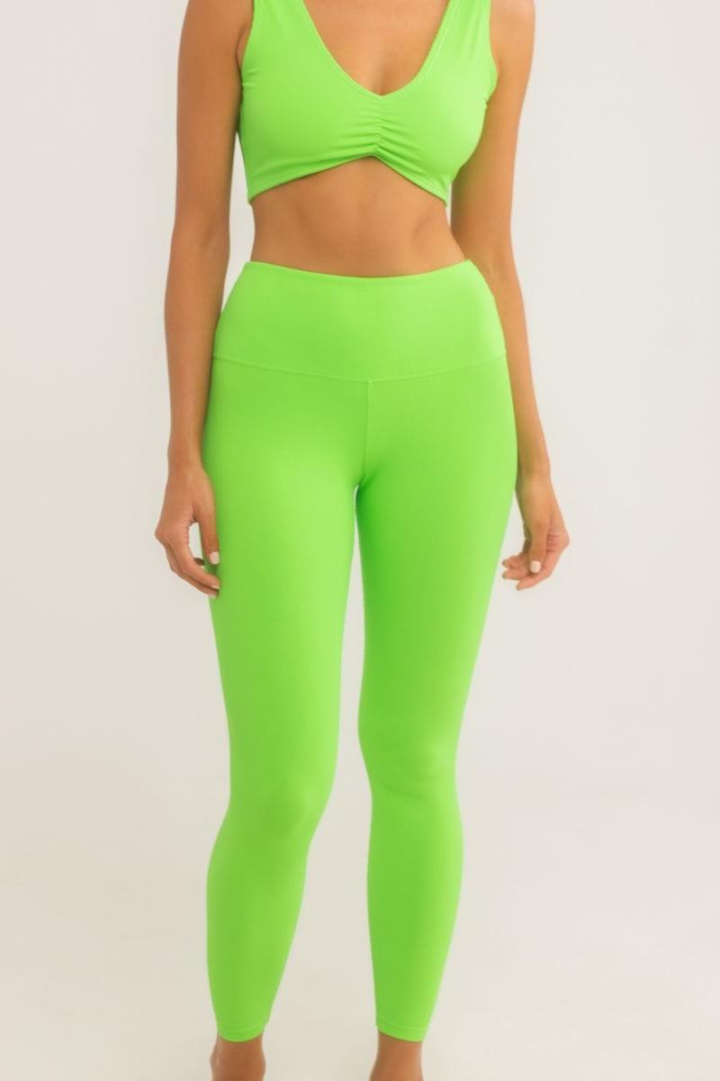 Bright green high-waisted legging with wide ribbed band, shown as part of matching two-piece set.