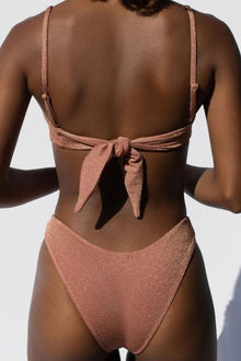Mauve sparkle bandeau bikini top with tie-back closure shown from rear view.