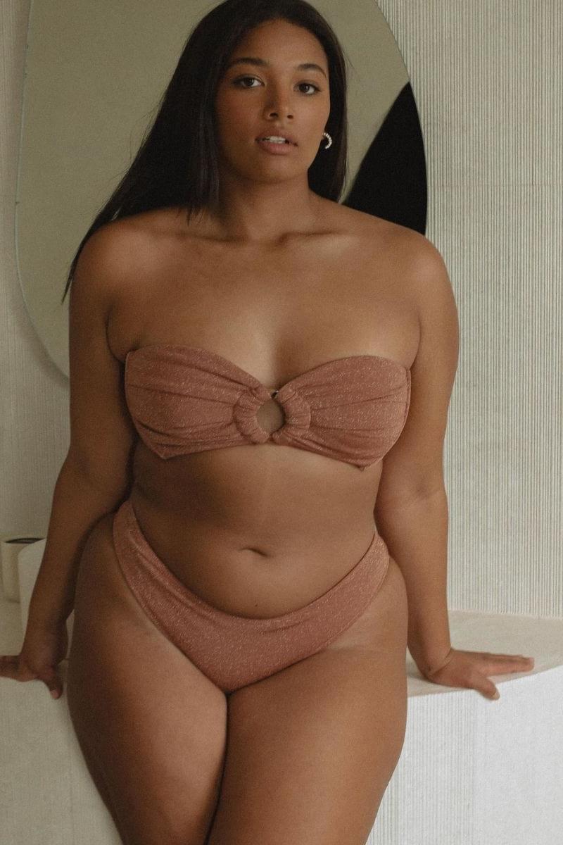 Mauve sparkle bandeau bikini top with tie closures at center front, shown on model.