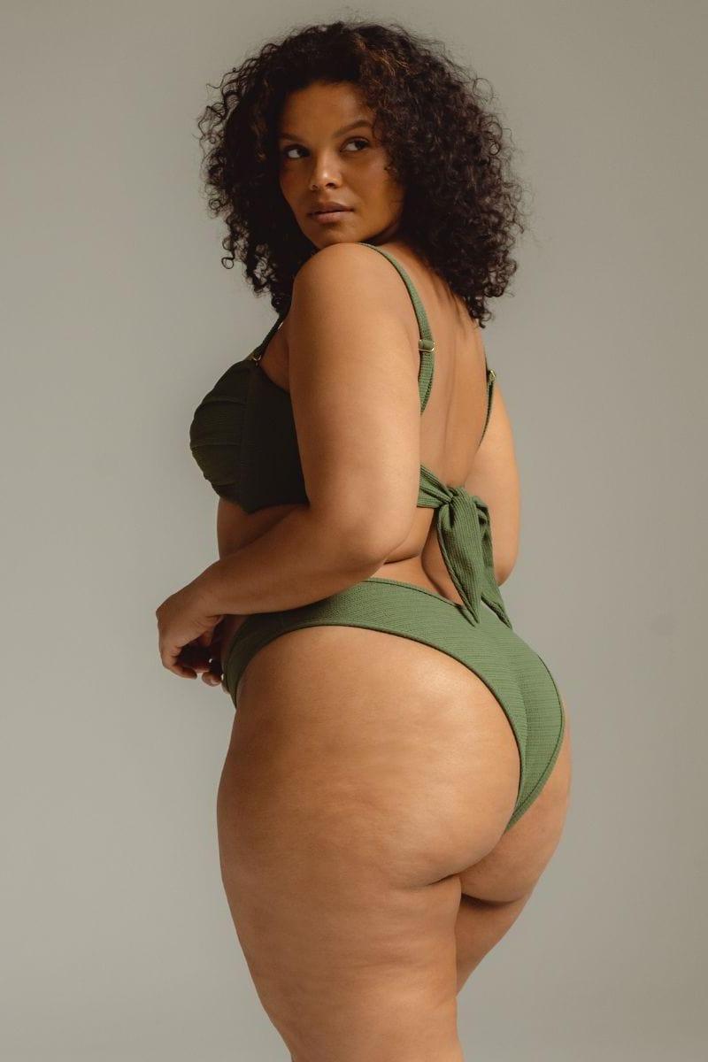 Olive green bandeau bikini top with tie-back closure, shown from behind on model.