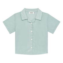 Powder blue short-sleeve button-down shirt with collar and white buttons on front.