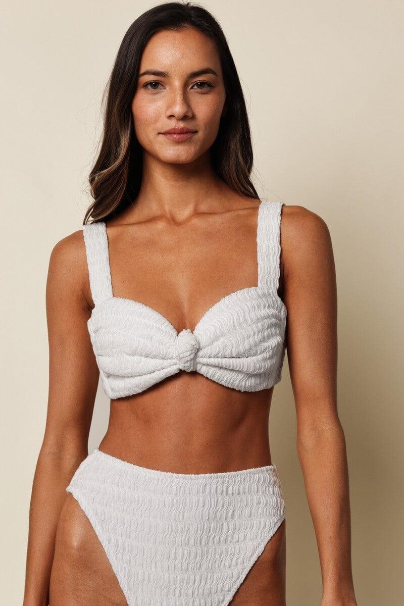 White textured bikini top with bow detail and square neckline on model.