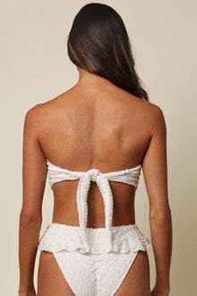 White bandeau bikini top with tie-back closure and textured fabric, shown from back view.