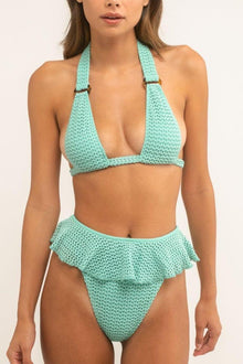 Turquoise crochet bikini bottom with tiered ruffle detailing at the front and textured knit fabric.