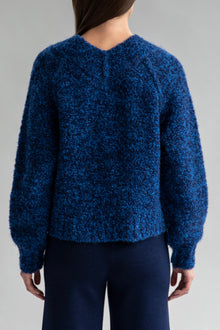 Full back view of a model wearing a Sky Navy alpaca-nylon blend sweater. Paired with matching wide leg trousers in navy.