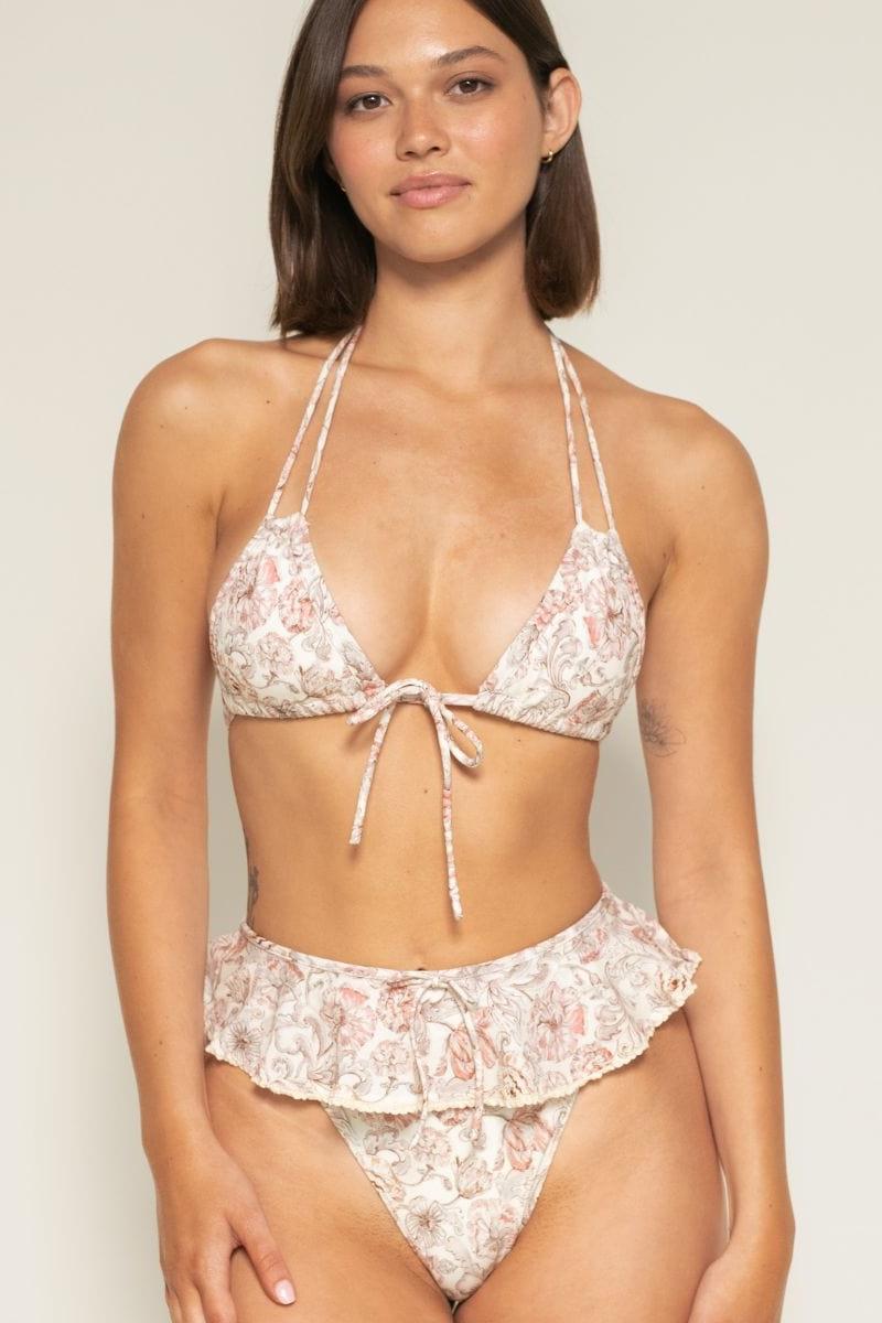 Beige and pink floral print bikini bottom with ruffled waistband and tie-front detail.