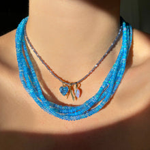 Shimmering beaded opal necklace made of smooth opals in shades of blue on a gold slim lobster clasp layered with a Iolite slim gemstone necklace with the blue lace agate acorn charm, Letter 