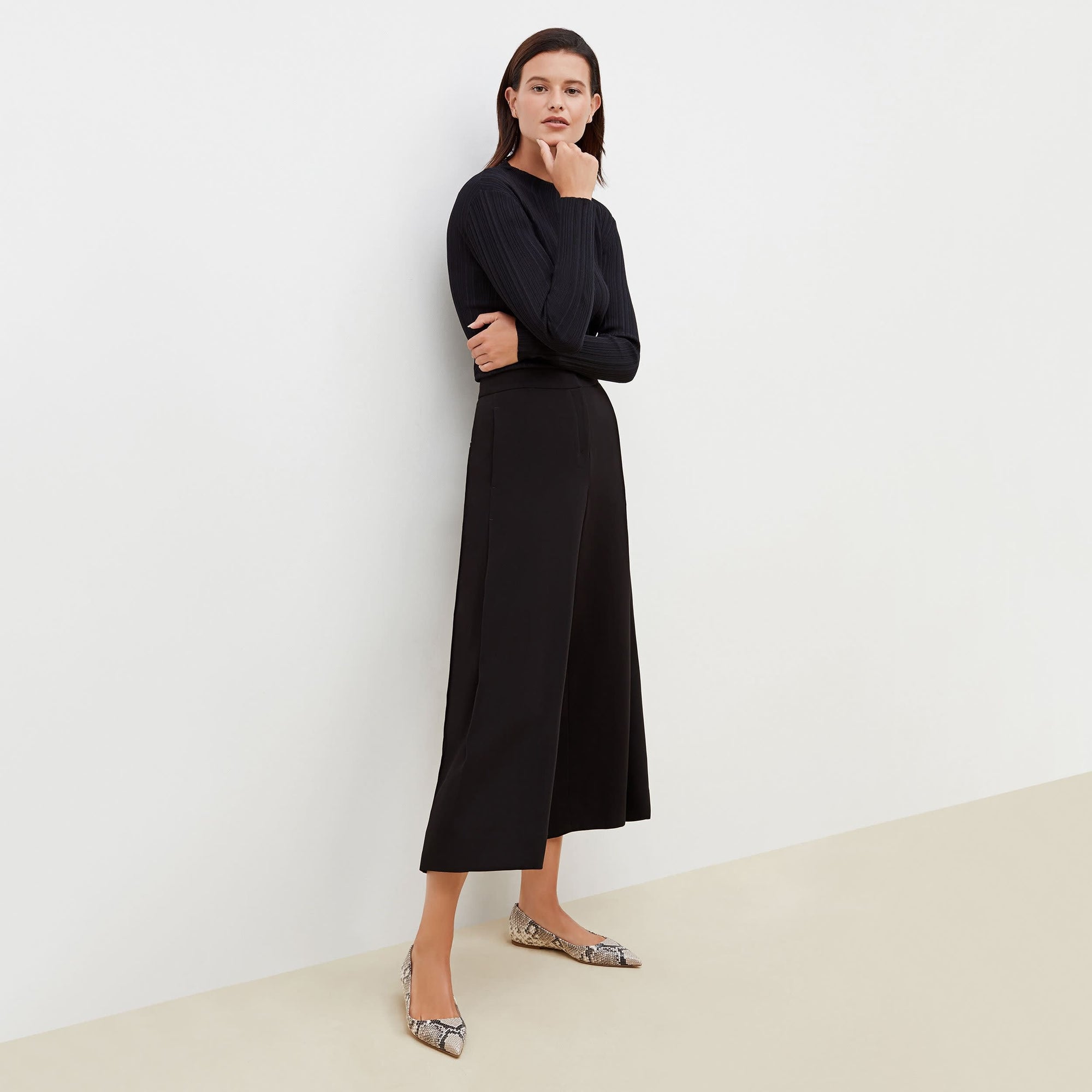 Front image of a woman standing wearing the Zhou culotte in black | Exclude