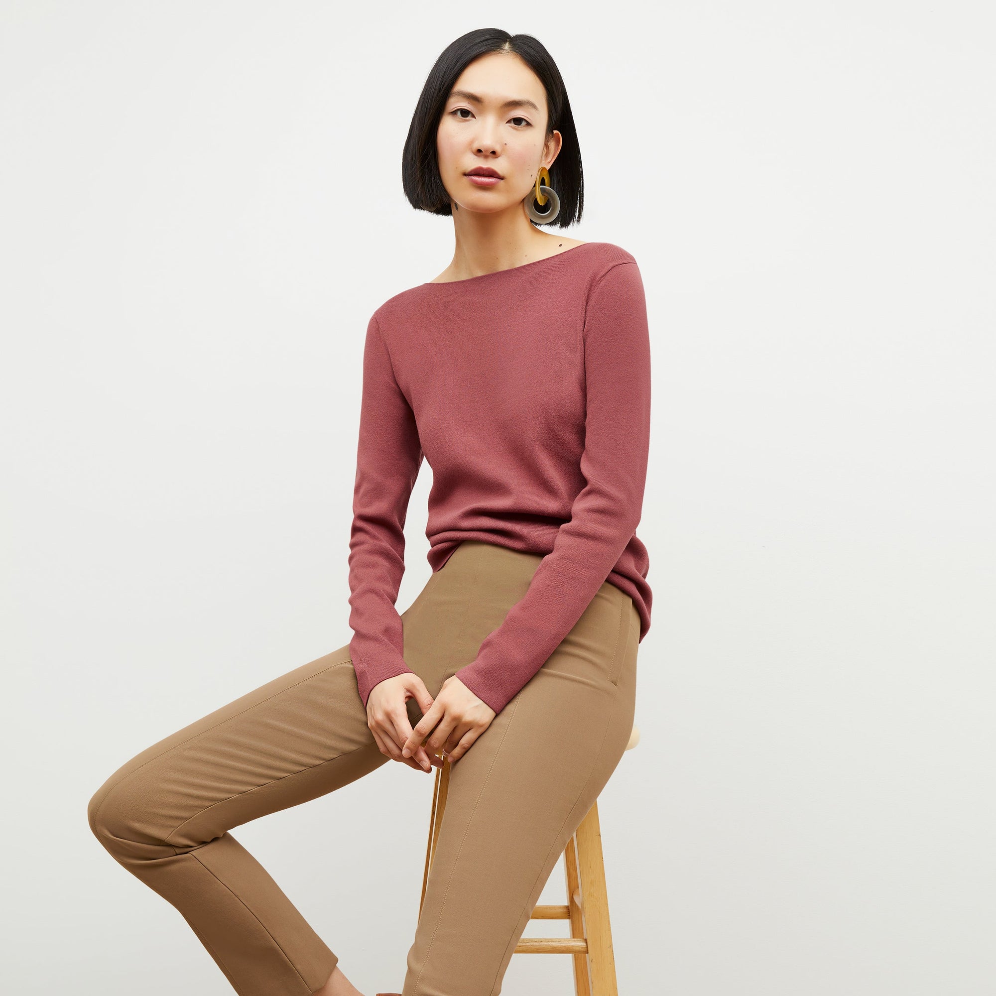 Front image of a woman sitting wearing the Foster Pant—Everstretch in Saddle | Exclude